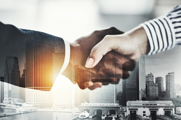 Hand shake, diversity and businesspeople with city, sale and agreement to contract with urban skyscraper. Thank you, greeting and double exposure in New York, recruitment and hiring for job or deal