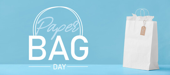 Paper shopping bag on color background