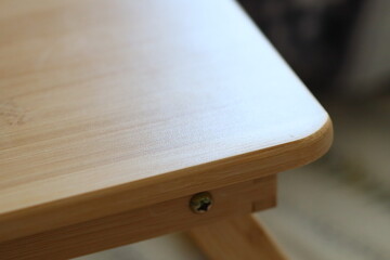 A close-up shot of a wooden tabletop with intricate details and texture.