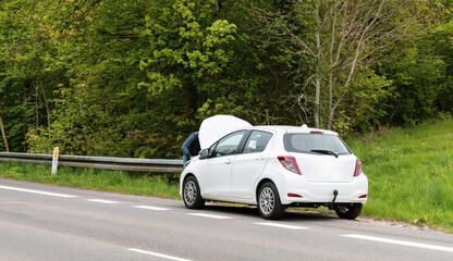 Broken car with open hood on the side of the highway. High quality photo