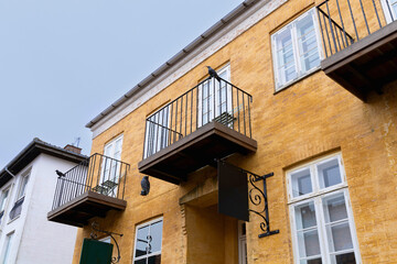 Obraz premium Facade of a yellow ancient building with a balcony. Denmark.