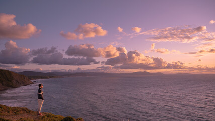 person watching the sea at sunset in Basque Country Biscay gulf