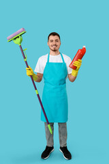 Male janitor with cleaning gel and mop on blue background