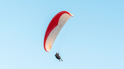 Paragliders in the sky. Man paragliding in a blue sky, on Cerro el Morro from Lechería, Venezuela