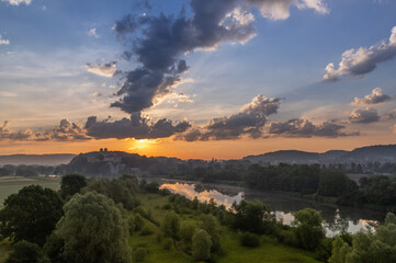 Colorful sunrise over Vistula river valley with Tyniec abbey on the hill near Krakow, Poland