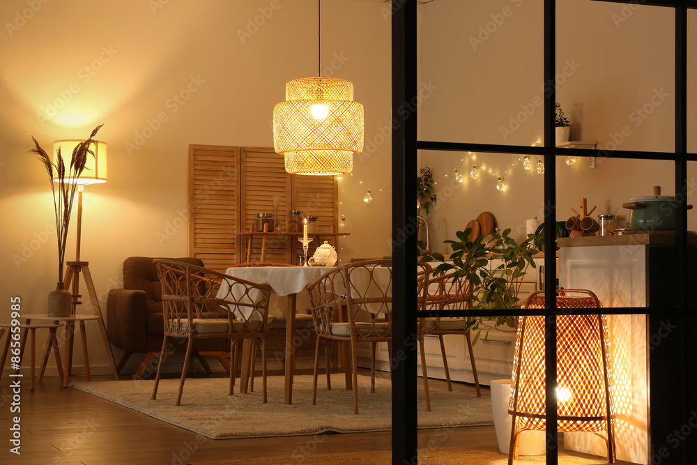 Wall mural Interior of modern kitchen with glowing lamps at evening