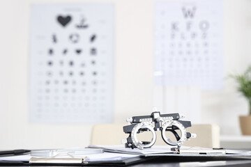 Trial frame with clipboards on table at oculist's office, closeup