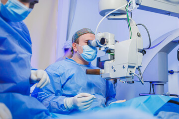 Man under a surgical microscope for vision correction. Eye surgery. A patient and a surgeon in the...