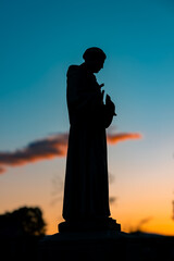 silhouette of a statue at sunset