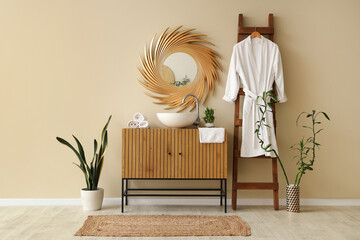 Interior of modern stylish bathroom with sink and hanging bathrobe