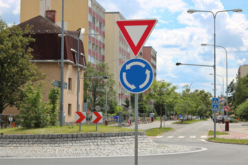 Road signs in front of the roundabout - give way and direction of travel © Monika