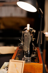 Close up shot of industrial expert level sewing machine used for cutting textile fabric materials and for embroidery in upscale tailoring workspace. Professional instrument in atelier shop studio