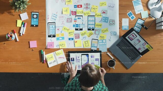 Top view of business woman looking and working at Ux Ui design. Top down aerial view of project manager picking stick notes with holograph with coding engineering prompt at meeting room. Convocation.