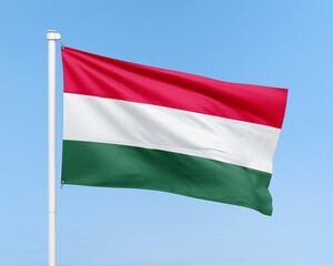 Obraz premium Hungary flag on stick on sky background. Realistic flag illustration