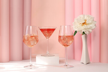 Modern summer still life with alcoholic cocktail Aperol spritz, champagne, pink martini and peony flowers on elegant modern background, minimal concept for bar and holiday party, cafe, 