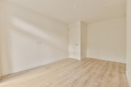 Minimalist empty room with natural light and wooden floor