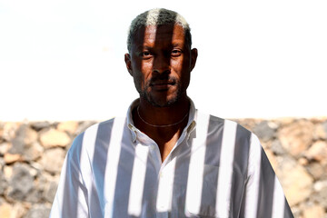 Mature man with graying hair looking directly at camera