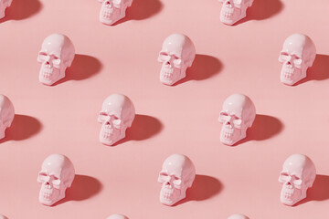 Creative Halloween background with pink human skulls and long shadows