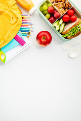 Flat lay school lunch with colorful school supplies, perfect for educational themes and healthy...
