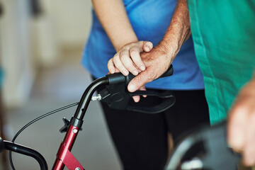 Obraz premium Nurse, elderly patient and hands with walker for retirement, homecare and support or wellness. Medical assistance, physiotherapy and rehabilitation from injury and person with disability in lounge