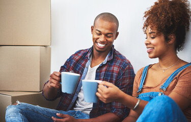 Couple, smile and coffee in new house with boxes for moving, investment and rental property....