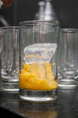 Cold drink in glass with ice and pineapple.