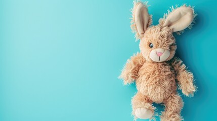 Obraz premium Soft toy bunny on bright blue background