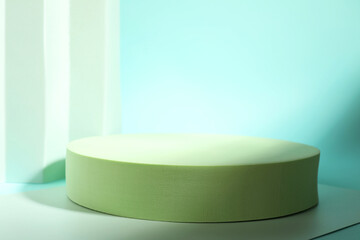 Presentation of product. Podium, paper and shadows on turquoise background. Space for text