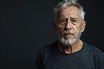 Obraz premium Serious senior man with grey hair looking at camera.