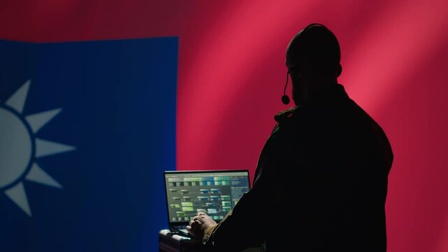 Taiwanese insurgent uses laptop to combat Chinese mass propaganda promoting One China policy, engaging in psychological operations. Taiwan spy defends against CCP PsyOp sabotage using device, camera A