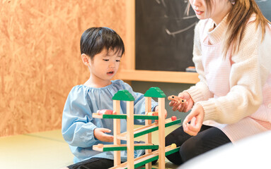 保育園・幼稚園・託児所・保育所で遊ぶ子供・赤ちゃんと保育士・ベビーシッター
