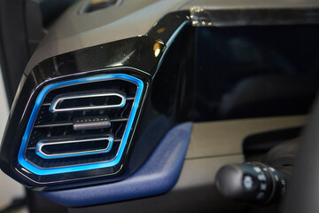 Closeup of car dashboard air vents near gear shift