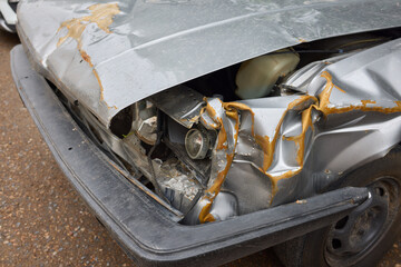 An accident in a parking lot resulted in frontend damage to a car due to a collision