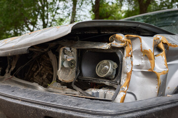 An accident in a parking lot resulted in frontend damage to a car due to a collision