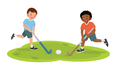 Fototapeta premium Cute little boys kids playing field hockey