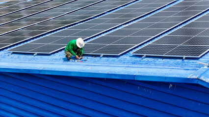 Worker Technicians are working to construct solar panels system on roof. Installing solar...