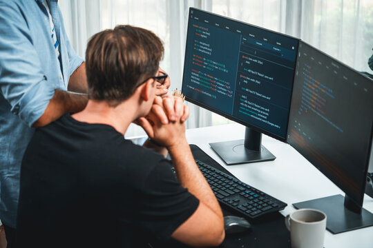 IT developers discussing online software development information on pc screen, creating program coding for latest version application on website. Concept of brainstorming firmware updated. Sellable.