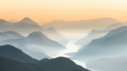 Fototapeta premium A breathtaking view of a mountain range at sunrise, with mist rising from the valleys and a river winding through the landscape.
