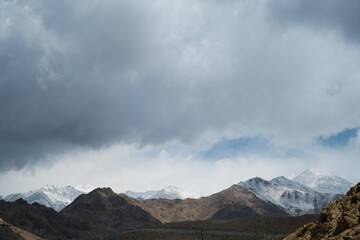 Panorama of mountains on snow peaks. The mountains are as vast as the eye can see.