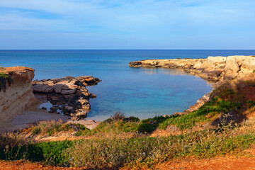 Beautiful seascape with cliffs and turquoise sea in Cyprus. Rocky shoreline with a body of water in the distance