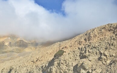Leh Mountain Peaks Shrouded in Clouds under Clear Blue Sky