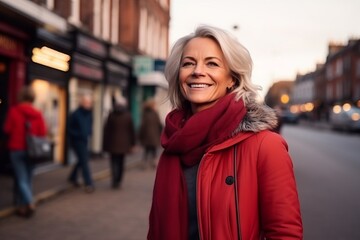 Fototapeta premium Portrait of a happy senior woman walking down a street in London