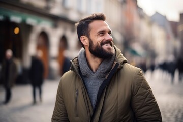 Naklejka premium Portrait of a handsome young man smiling in a city street.