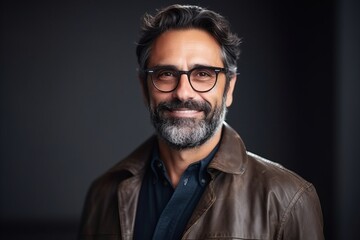 Obraz premium Portrait of a handsome mature man in leather jacket and glasses.