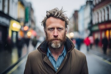 Obraz premium Portrait of a handsome middle aged man with long gray hair and beard in a urban context