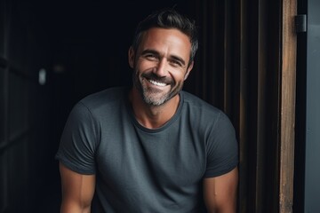 Fototapeta premium Portrait of a handsome middle-aged man smiling at the camera