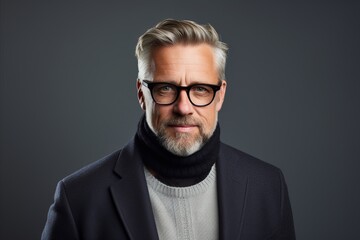 Obraz premium Portrait of a handsome mature man with grey beard and glasses.