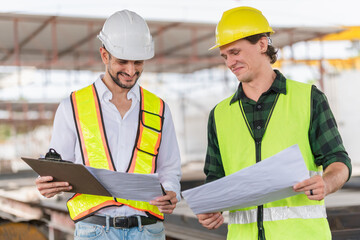 Cheerful engineer and foreman worker team inspect the construction site, Site manager and builder on construction site
