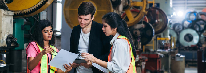Engineers or foreman inspecting and check up machine at factory machines. Worker industry working in the metal sheet company.