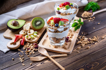 Greek Yogurt homemade with berries, avocado, banana and granola. It's healthy menu and low calories for people who diet. the high quality picture for artwork and graphic design
